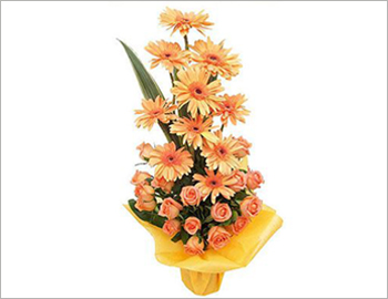 An arrangement of bright orange gerberas in a cane basket.; A lovely arrangement of bright orange gerberas - sure to light up any occasion, tastefully arranged in a cane basket.