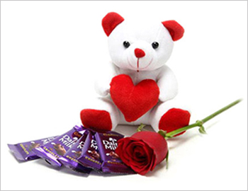 A Fresh Rose along with Small Teddy and a Dairy Milk Chocolates; Small teddy bear around 6 inches size, Five Dairy Milk Chocolates - each 23 gms and One Red Rose 